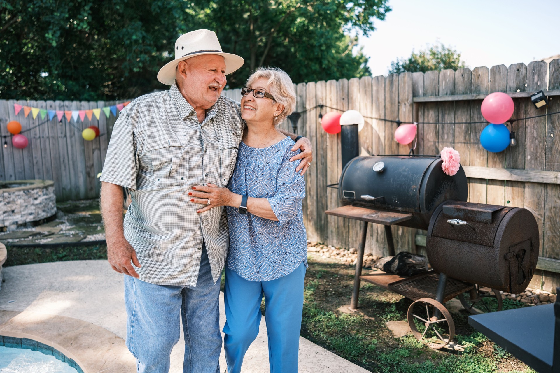 Senior Latino couple at the backyard party